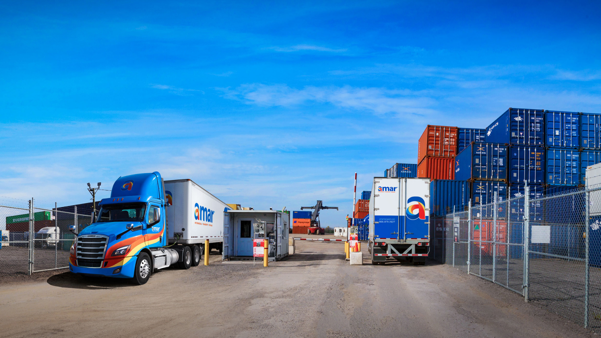 Photo of Amar container yard with company trucks going through entry and exit security gate