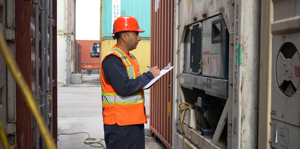 Amar container yard staff inspecting refrigerated container unit
