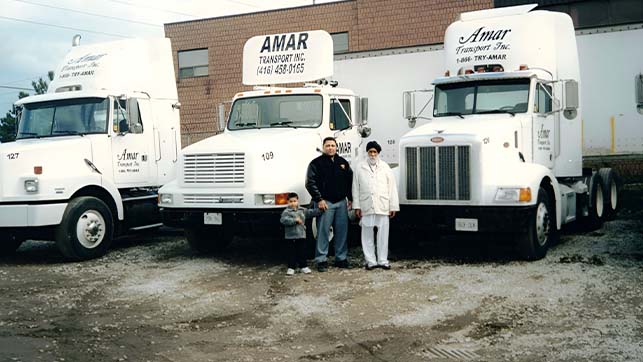 3 white parked Amar trucking cabs parked at its first terminal in Mississauga, ON