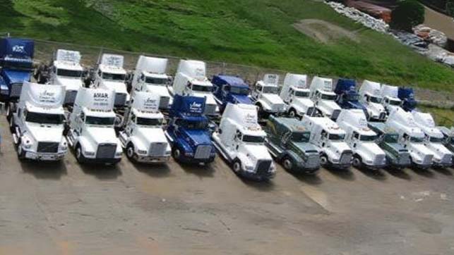 Overhead view of ~50 white and blue Amar trucking cabs