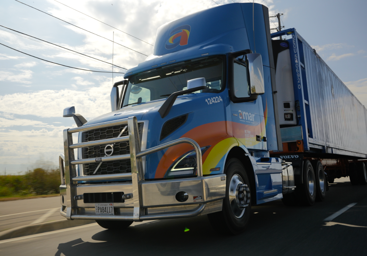 Front view of Amar truck transporting company-owned 53’ trailer on North American highway