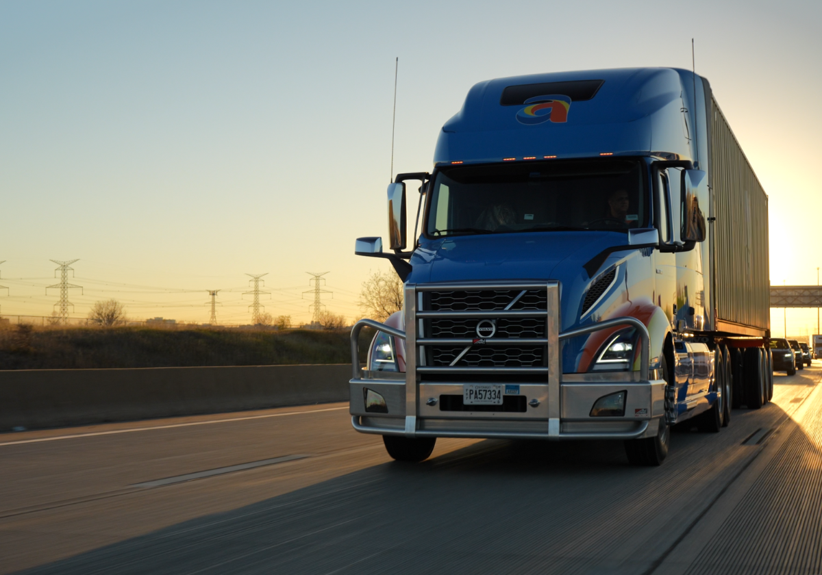 Front view of Amar truck transporting 53’ container on North American highway