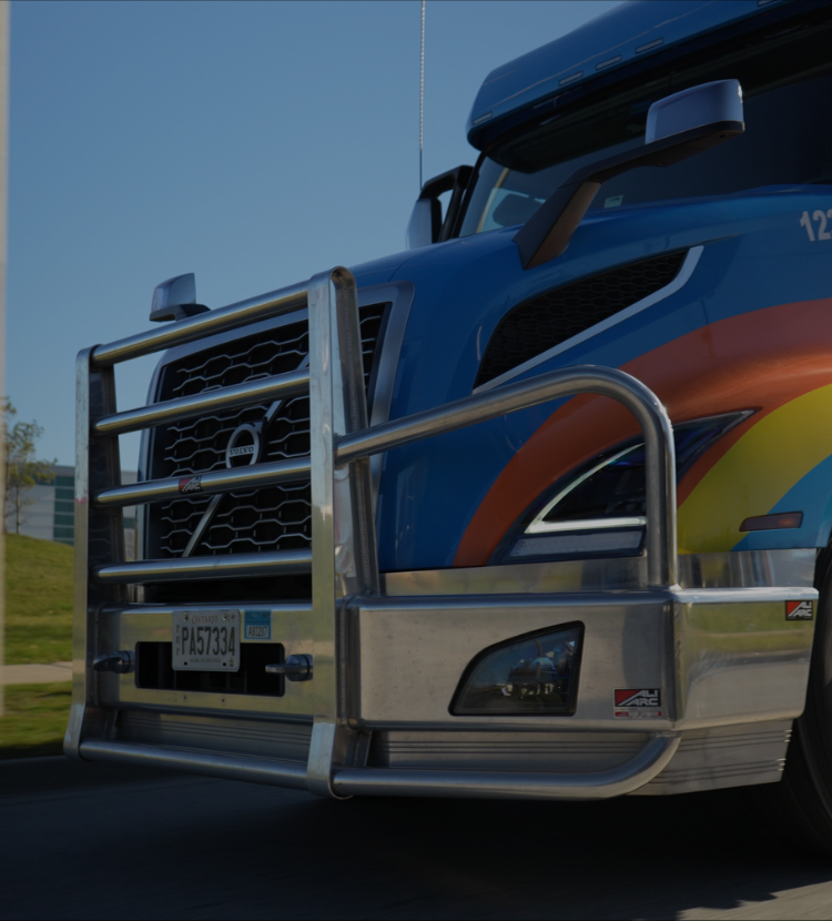 Closeup of front of Amar Group highway cab